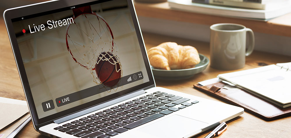 A live stream of a basketball game on a laptop